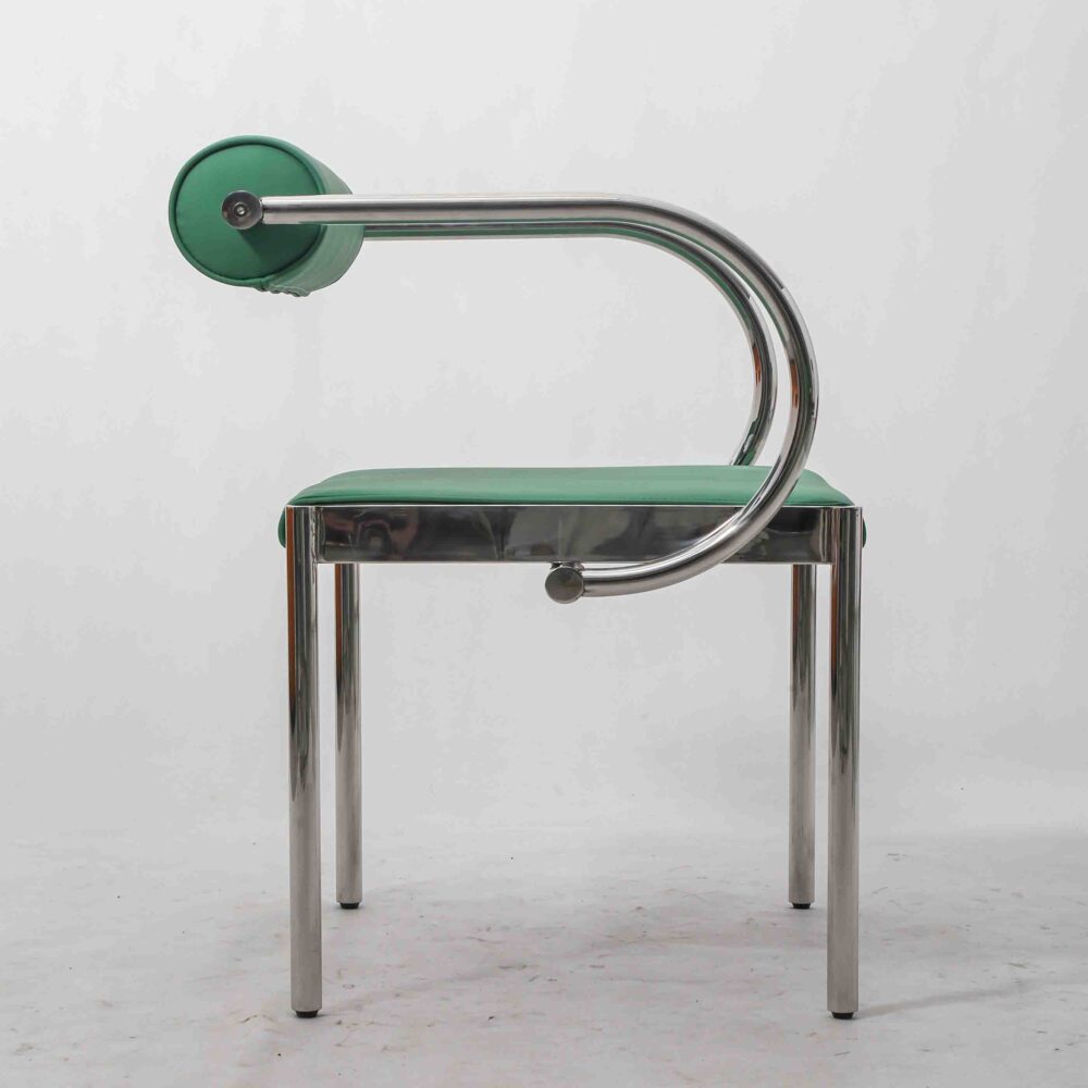Italian postmodern armchair with PU leather upholstery and stainless steel tubular frame, side view.