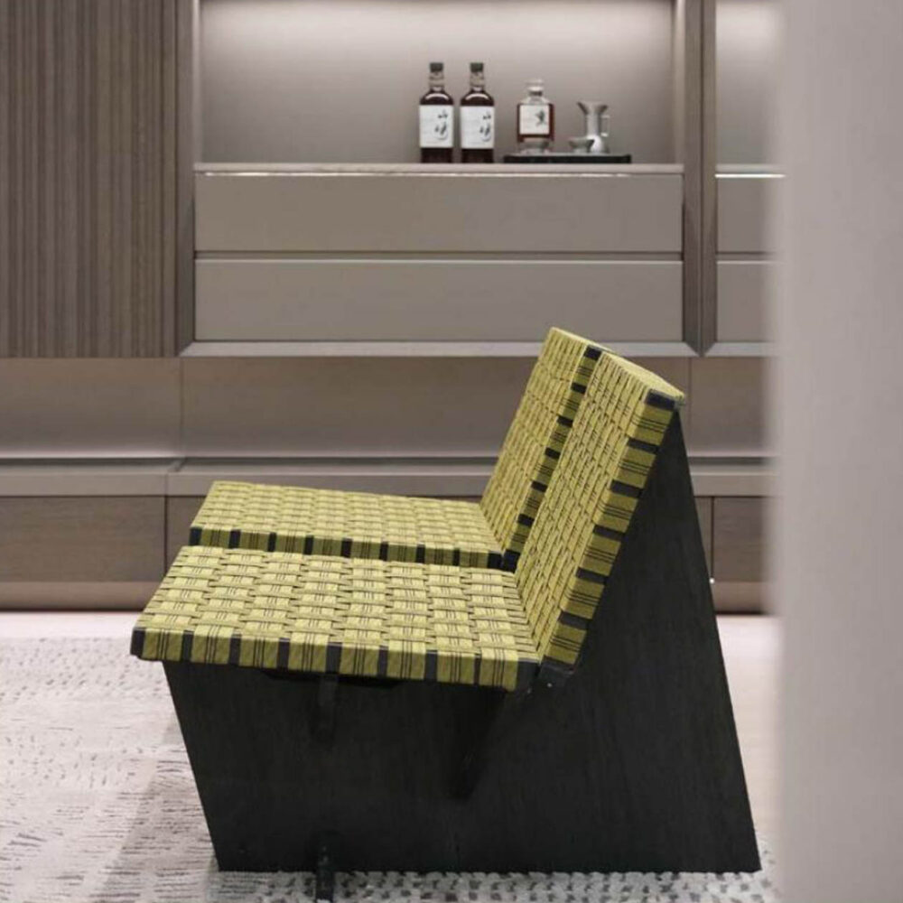 Single-seat yellow woven chair with minimalist birch wood legs