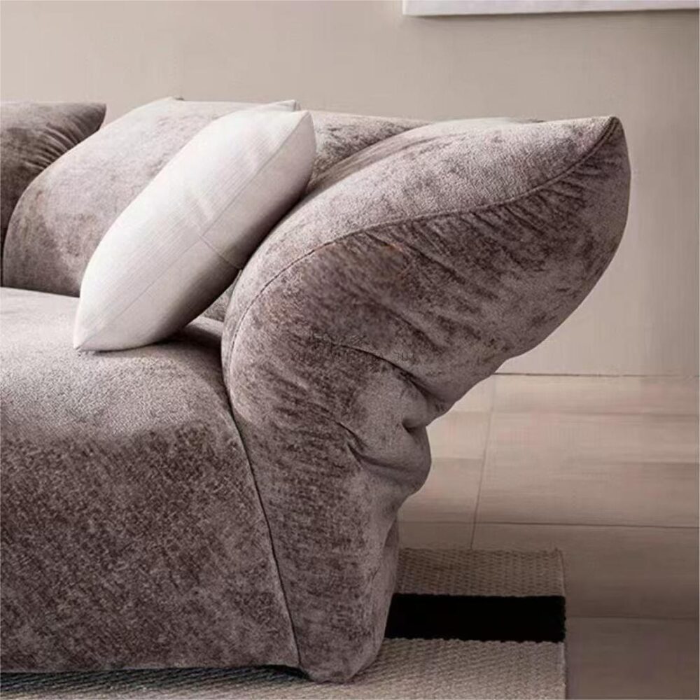 Elegant and spacious modern minimalist living room featuring a plush chenille petal sofa with customizable lumbar support.
