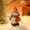 Cute resin snowman holding red gift bag, wearing pointed Santa hat – festive holiday decoration.