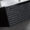Floating vanity unit with textured black cabinet and vessel sinks