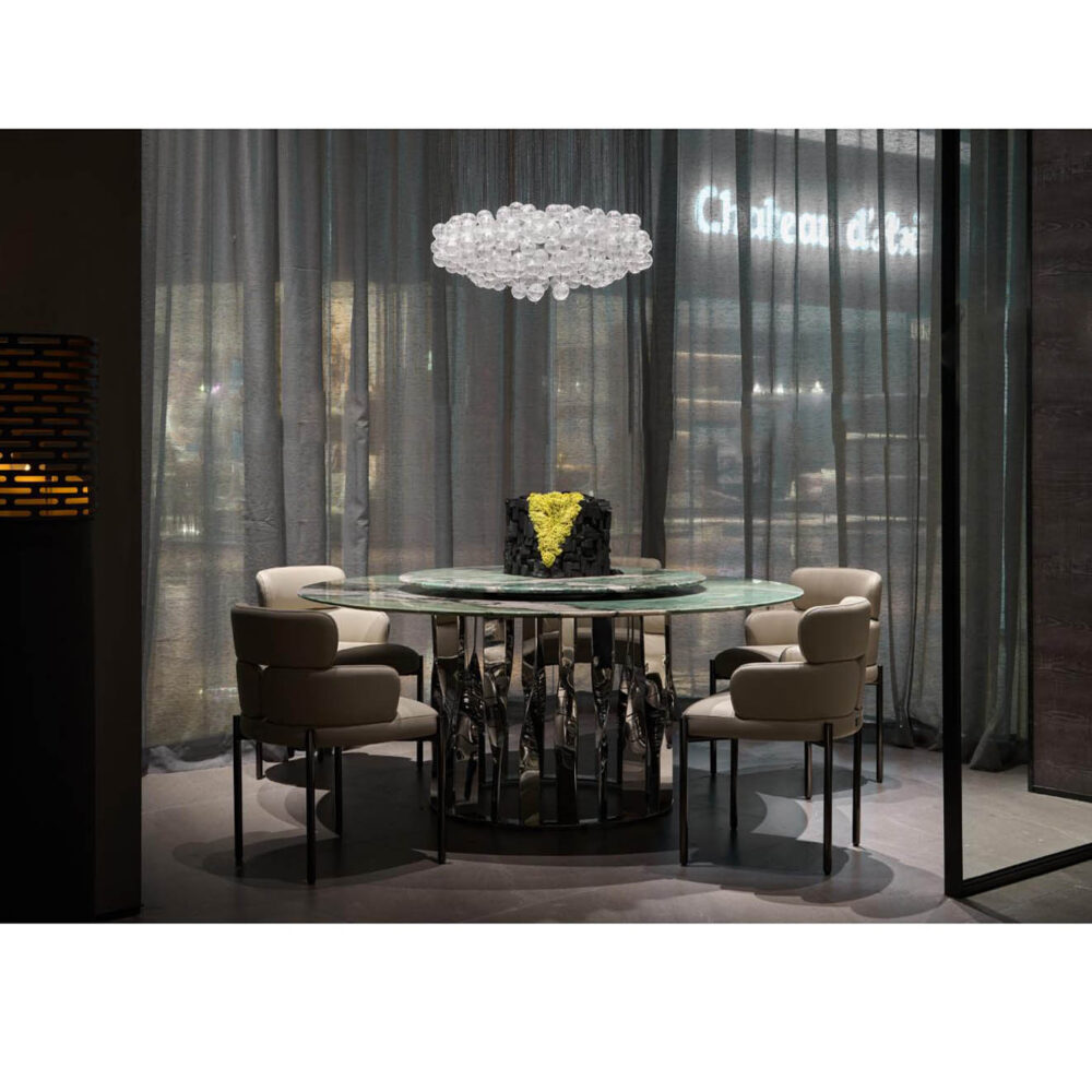 Full view of luxury green marble round dining table with Lazy Susan centerpiece in a spacious, upscale restaurant1