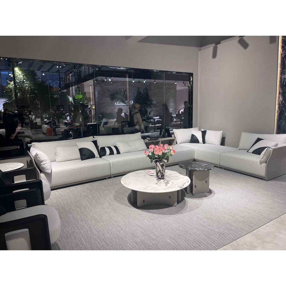 Luxury living room showroom featuring Old Money style sectional sofa and elegant built-in bookshelf baseboard