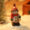 Snowman in brown outfit with red scarf and Christmas hat – mini resin winter holiday figurine.