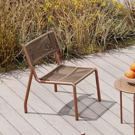 Orange rattan chair placed in a luxury garden patio
