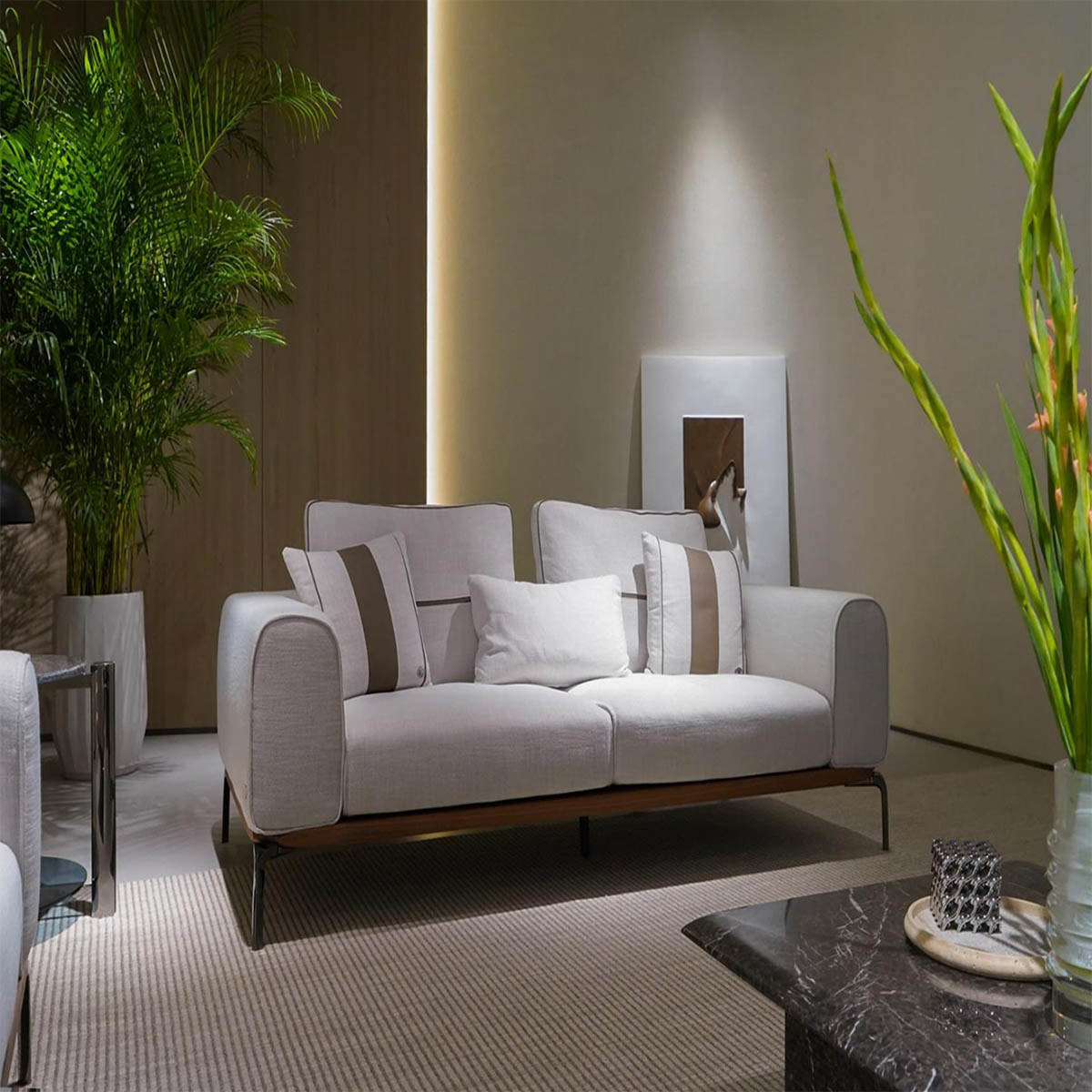 High-end Italian modular sofas in modern furniture showroom with marble walls and glass partitions.